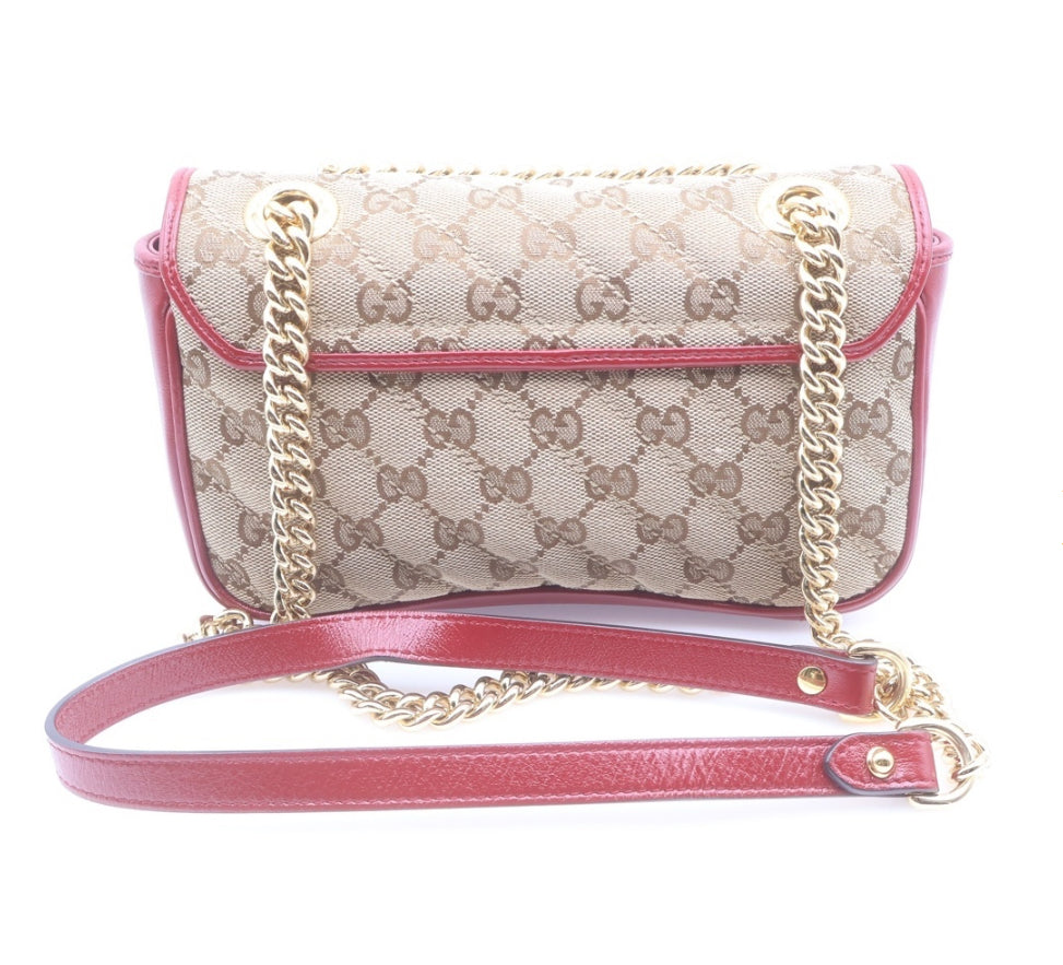 GUCCI Small GG Marmont Matelassé Diagonal GG Canvas and Leather shoulder bag.