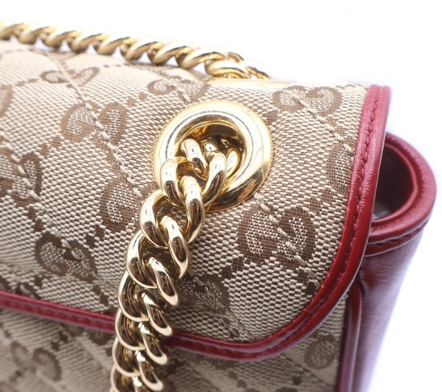 GUCCI Small GG Marmont Matelassé Diagonal GG Canvas and Leather shoulder bag.