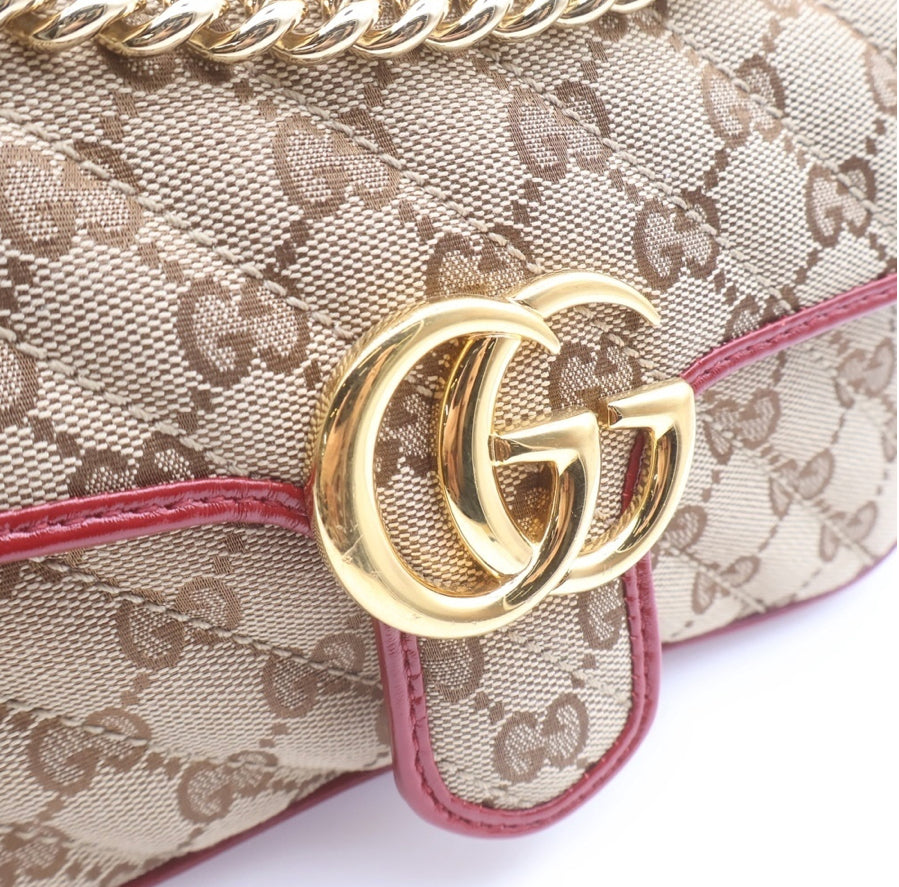 GUCCI Small GG Marmont Matelassé Diagonal GG Canvas and Leather shoulder bag.